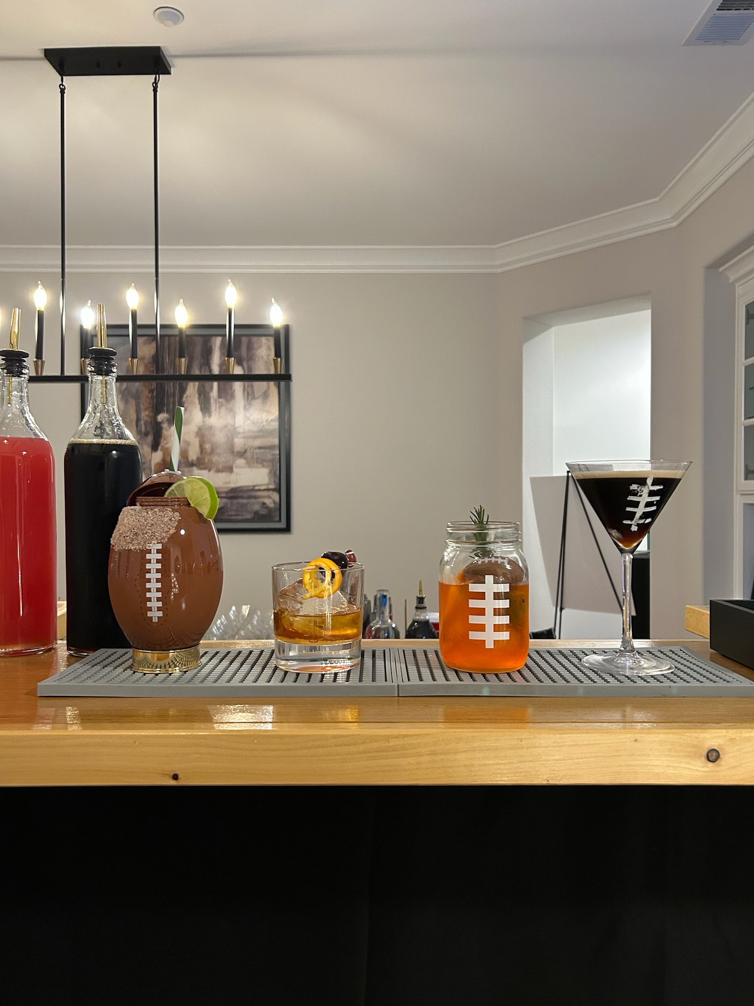 Football-themed cocktails including a football-shaped cup, a mason jar, and an espresso martini for a game day party