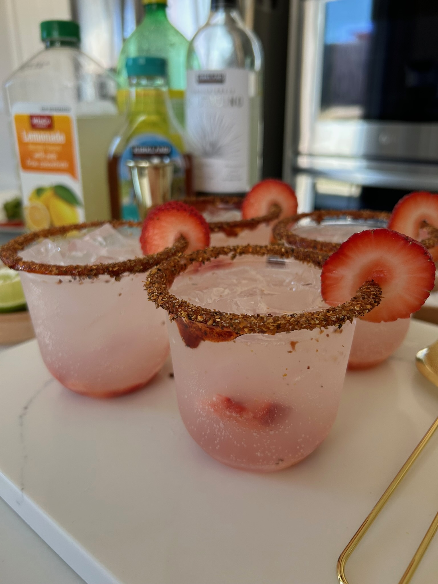 Strawberry margaritas with tajin spice rim and fresh strawberry slices